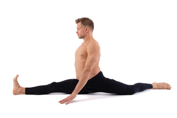 A young attractive man with an athletic body is doing fitness. White background.