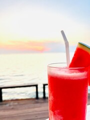 Watermelon Shake Glass blurred sea background. Summer time. Selective focus. Blurry background