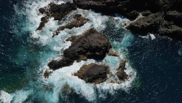 Fly over playa de rojas beach across rough coast with splashing waves