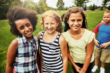 Kids, park and portrait of group in playground to relax with friends on field on vacation. Happy, holiday and children together for party, games or smile outdoor at middle school on break at recess