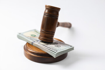 Law gavel with stack of dollars on white background