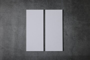 Blank business cards on grey textured background, top view. Mockup for design
