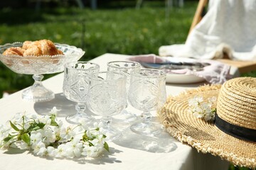 Beautiful table setting with spring flowers in garden on sunny day
