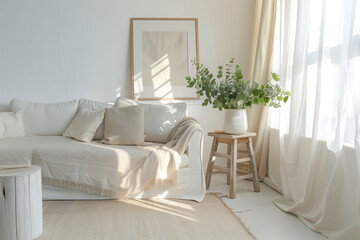 A bright and airy living room with a white sofa, soft beige rug on the floor, wooden side table holding greenery, large window draped in sheer curtains. A framed picture hangs above the couch.