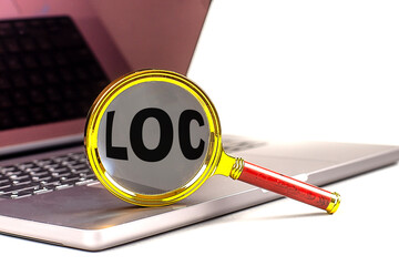LOC word on magnifier on laptop , white background