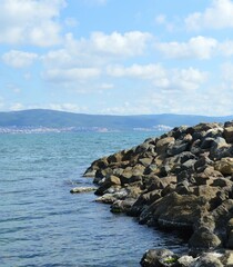 Stones on the seashore against the background of mountains - Nessebar, Burgas, Sunny Beach