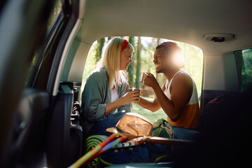 Happy couple having fun in their camping van in nature.