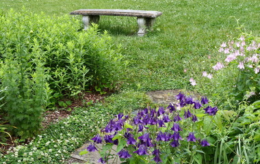 Decorative Concrete Bench in Garden with Flowers and Grass