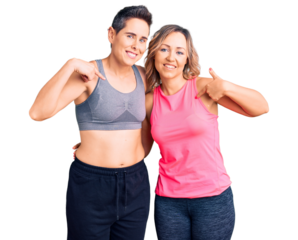 Couple of women wearing sportswear looking confident with smile on face, pointing oneself with fingers proud and happy.