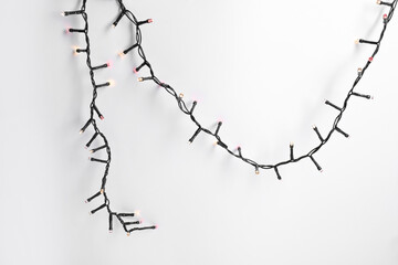 Beautiful Christmas lights on white background, top view