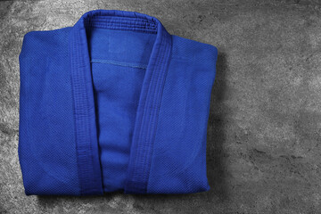 Blue kimono on gray textured background, top view. Space for text