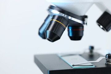 Modern microscope on light background, closeup view