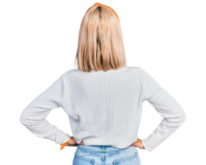 Beautiful young blonde woman wearing casual white sweater standing backwards looking away with arms on body