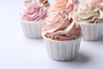 Many tasty cupcakes on white background, closeup