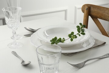 Stylish setting with cutlery and plates on white textured table