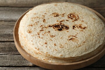 Stack of tasty homemade tortillas on wooden table
