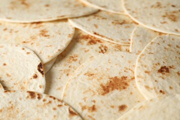 Many tasty homemade tortillas as background, closeup