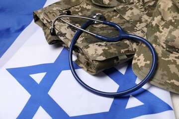 Stethoscope and military uniform on flag of Israel, closeup