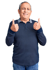 Naklejka premium Senior handsome man wearing casual polo success sign doing positive gesture with hand, thumbs up smiling and happy. cheerful expression and winner gesture.