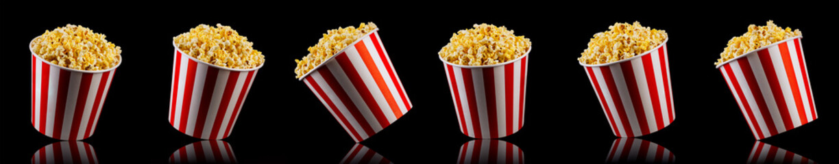 Set of paper striped bucket with popcorn isolated on black background