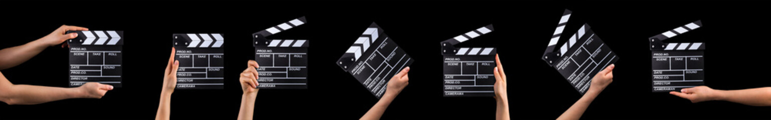Human hand holding film clapper board isolated on black background.
