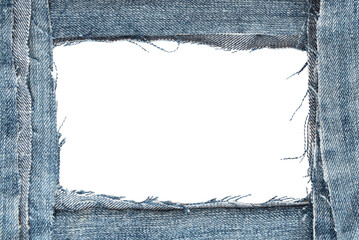 Hole in denim on a white background. Ripped jeans