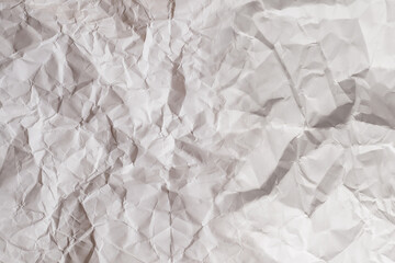 Crumpled white paper background.