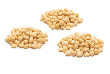 Macadamia nuts isolated on white background.
