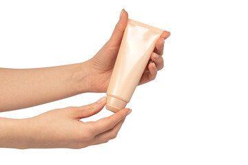 Beige cream tube in woman hands isolated on a white background.