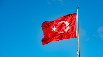 Turkish Flag waving in blue sky.