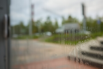 A robotic white Automotive tire is cleaning a glass window