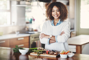 Cooking, meal and woman with food for vegetables, fresh and dinner in home. Vegan, diet and arms crossed with portrait and recipe for nutrition, smile and female person in kitchen with ingredients