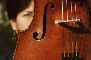 Old cello close-up. Girl and the cello