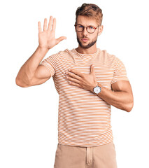 Young caucasian man wearing casual clothes and glasses swearing with hand on chest and open palm,...
