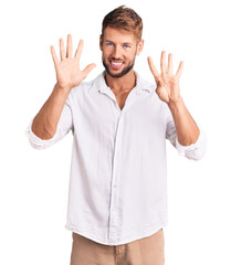 Young caucasian man wearing casual clothes showing and pointing up with fingers number nine while...