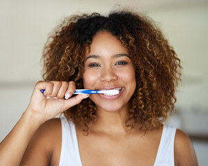 Black woman, portrait and toothbrush for smile with teeth in bathroom with dental hygiene in house....