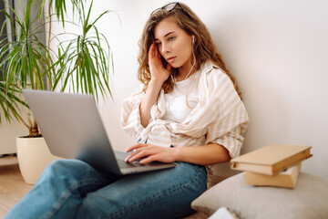 Young  IT woman use work on laptop  stay at home, hotel, spend free spare time in living room...