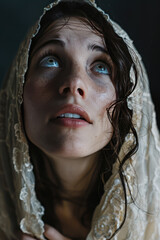 Biblical close up portrait of young woman in a veil headscarf praying, copy space.