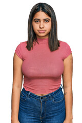 Obraz premium Young hispanic girl wearing casual t shirt depressed and worry for distress, crying angry and afraid. sad expression.