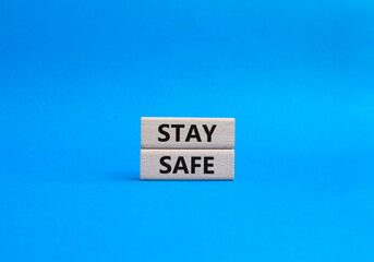 Stay Safe symbol. Concept word Stay Safe on wooden blocks. Beautiful blue background. Business and Stay Safe concept. Copy space