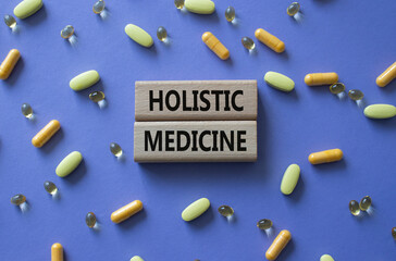 Holistic Medicine symbol. Concept word. Holistic Medicine on wooden blocks. Beautiful purple...