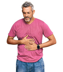 Middle age grey-haired man wearing casual clothes with hand on stomach because indigestion, painful illness feeling unwell. ache concept.