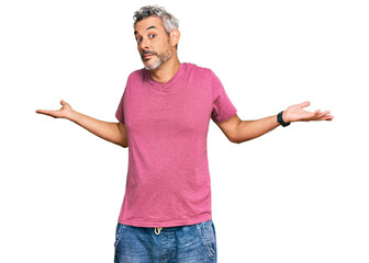 Middle age grey-haired man wearing casual clothes clueless and confused expression with arms and...