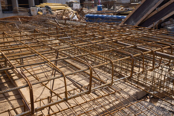 A metal structure is being constructed on site with engineering precision