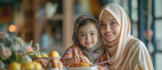 Muslim woman with her mother and little daughter in the month of Ramadan preparing table food at home