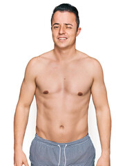 Fototapeta premium Handsome young man wearing swimwear shirtless winking looking at the camera with sexy expression, cheerful and happy face.