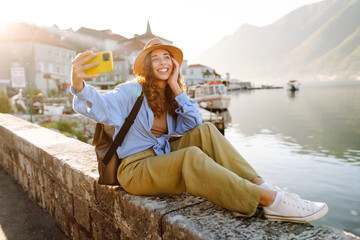 Female tourist taking selfie photos on sightseeing.  Selfie time. Lifestyle, adventure, nature,...