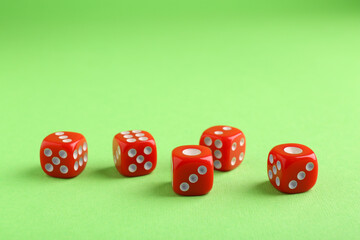 Many red game dices on green background
