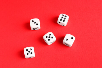 Many white game dices on red background, flat lay