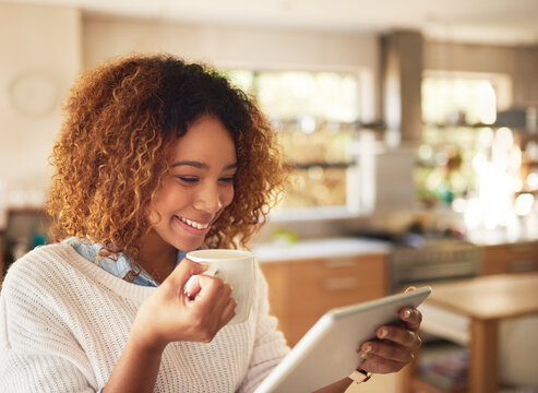 Woman, tablet and smile with coffee in home for communication, break and social media post. Technology, female person or remote worker browsing internet for online news, reading blog or research